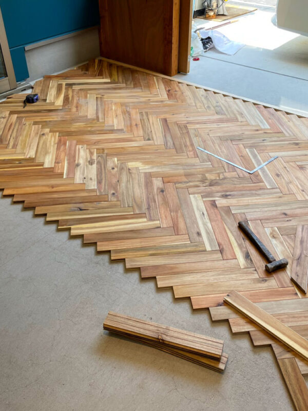 アカシア無垢フローリングをヘリンボーン貼りで施工中