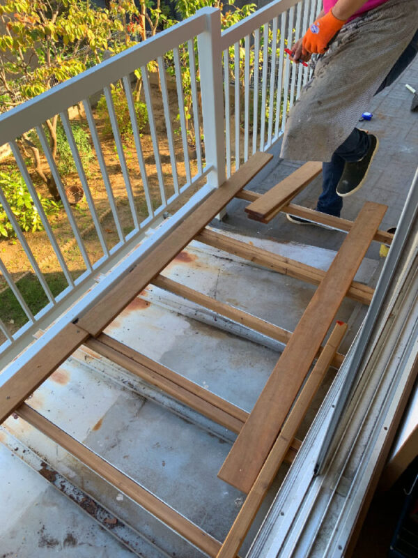 セランガンバツ材をバルコニーに仮置きして配置を確認している様子