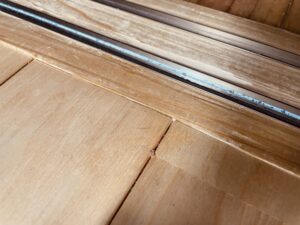 無垢フローリングの突き上げによる床鳴りが発生した部分の様子。サッシ際で木が浮き上がっている。